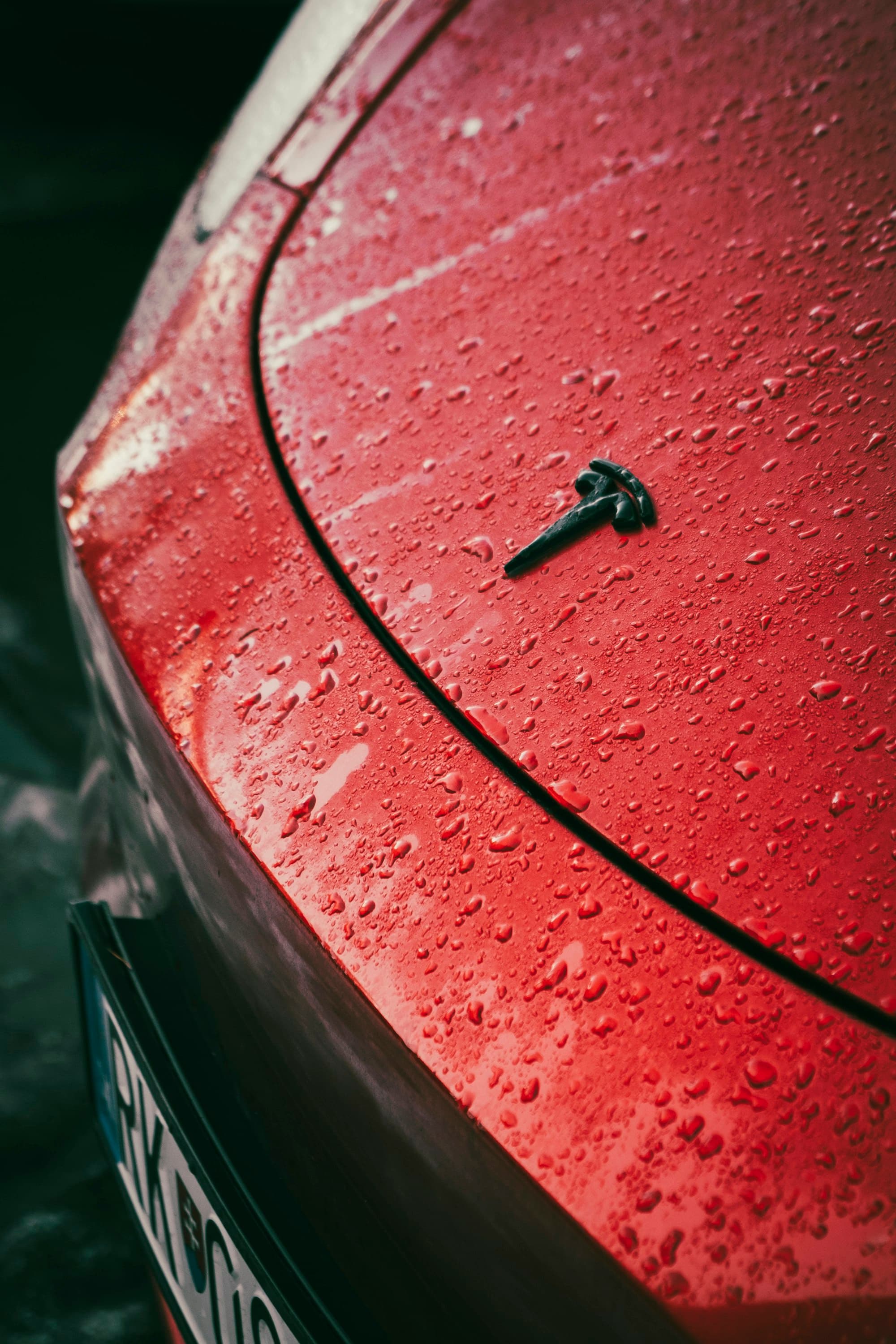 Water beading on glossy red paint