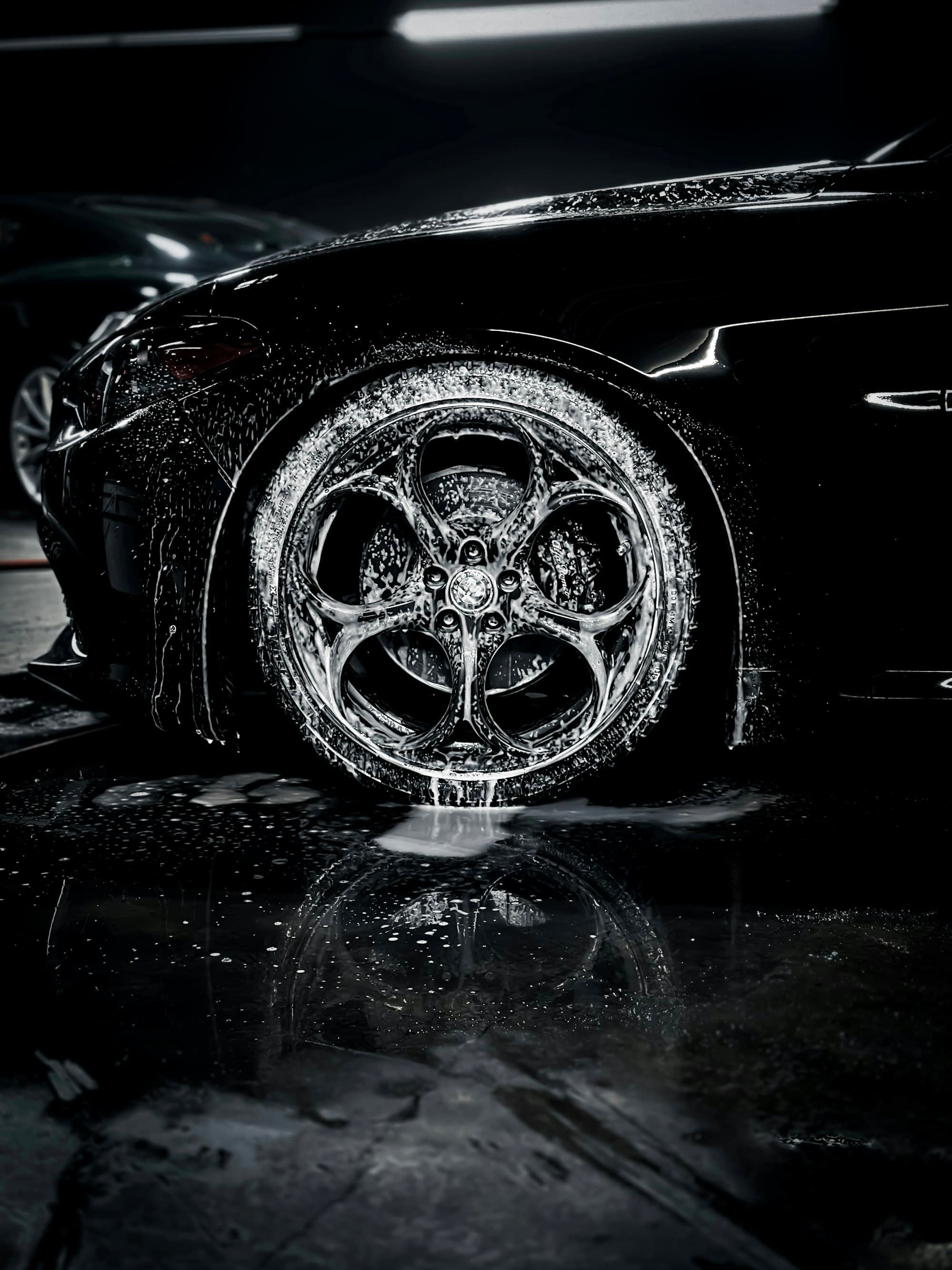 Foam-covered alloy wheel on a black car