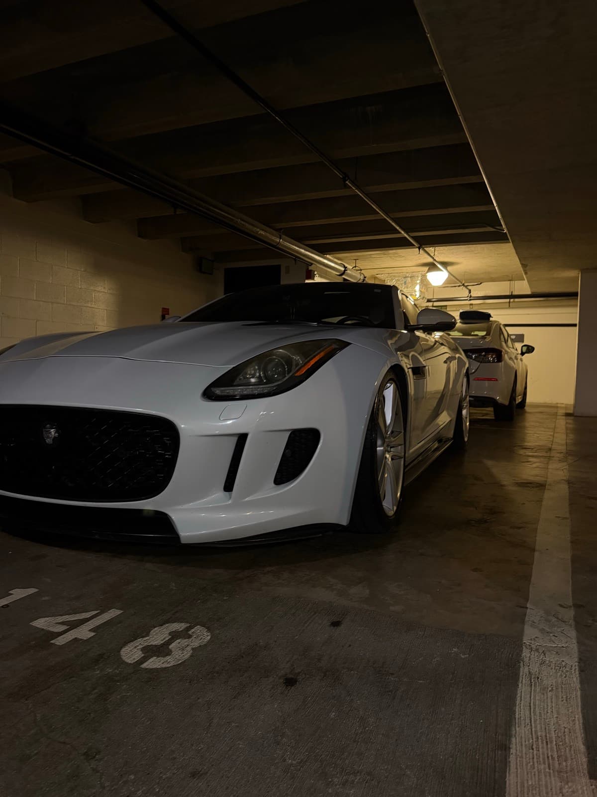 White exotic sports car exterior detail — Honolulu parking structure, Oahu Hawaii