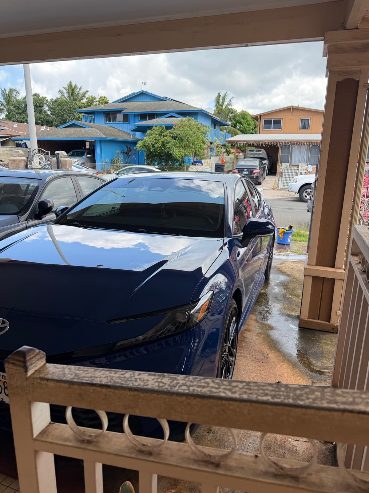 Dark blue Lexus sedan exterior detail in tropical neighborhood — Kaimuki, Oahu Hawaii
