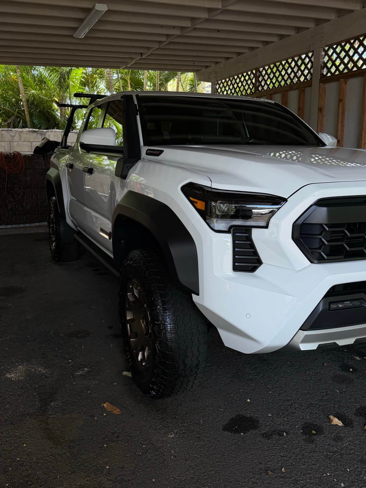 White lifted truck exterior detail in tropical driveway — Ewa Beach, Oahu Hawaii