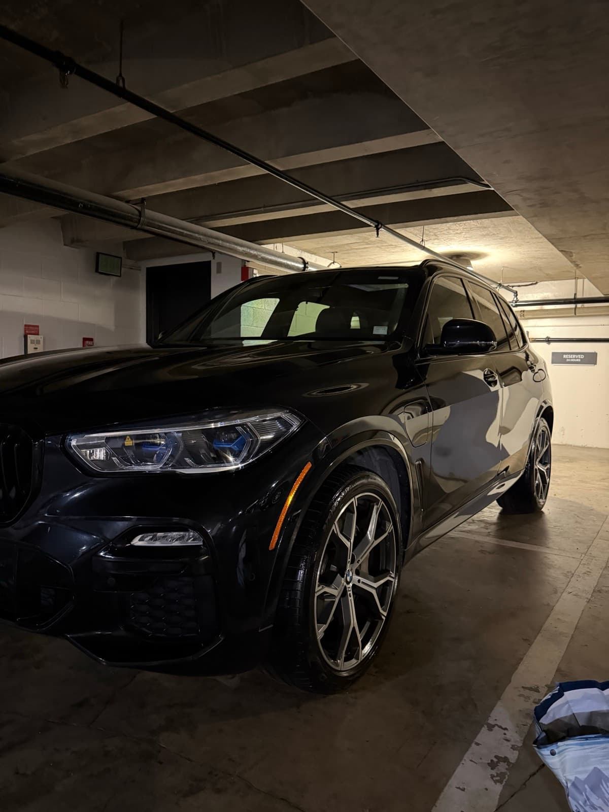 Black luxury SUV exterior detail — Honolulu condo parking garage, Oahu Hawaii